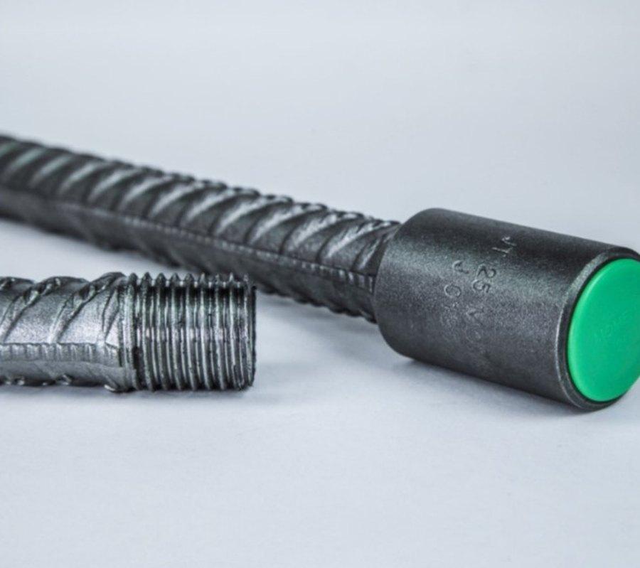 A capped bar end beside a bare threaded bar end ready for a coupler